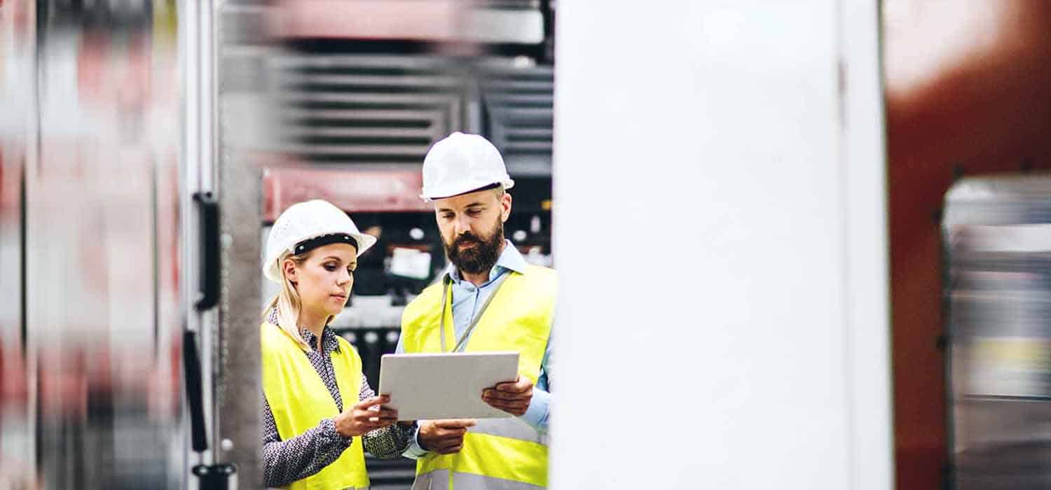 two employees completing health and safety checks in heavy industry engineering environment